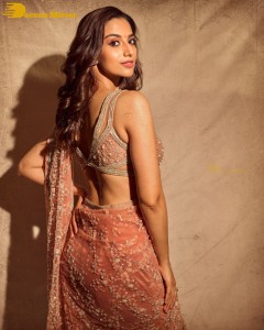 Meenakshi-Chaudhary in a light orange saree