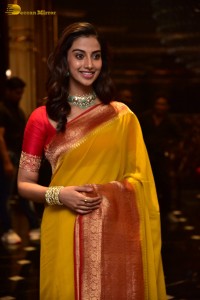 Indian Actress Meenakshi Chaudhary in a yellow saree