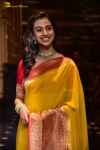 Indian Actress Meenakshi Chaudhary in a yellow saree