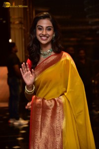 Indian Actress Meenakshi Chaudhary in a yellow saree