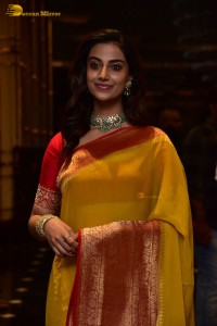 Indian Actress Meenakshi Chaudhary in a yellow saree