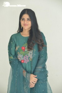 Actress Megha Akash posing for pictures in a green salwar kameez