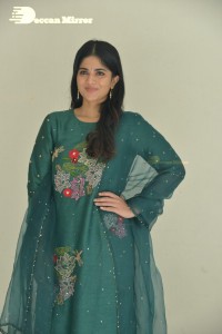 Actress Megha Akash posing for pictures in a green salwar kameez