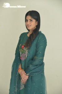 Actress Megha Akash posing for pictures in a green salwar kameez