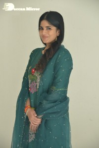 Actress Megha Akash posing for pictures in a green salwar kameez