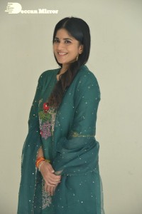 Actress Megha Akash posing for pictures in a green salwar kameez