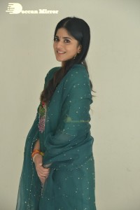 Actress Megha Akash posing for pictures in a green salwar kameez