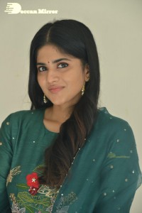 Actress Megha Akash posing for pictures in a green salwar kameez