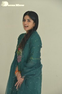 Actress Megha Akash posing for pictures in a green salwar kameez