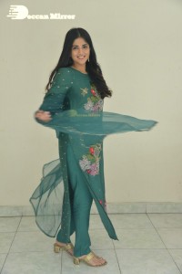 Actress Megha Akash posing for pictures in a green salwar kameez
