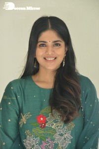 Actress Megha Akash posing for pictures in a green salwar kameez