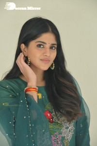 Actress Megha Akash posing for pictures in a green salwar kameez