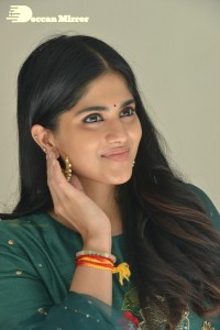 Actress Megha Akash posing for pictures in a green salwar kameez