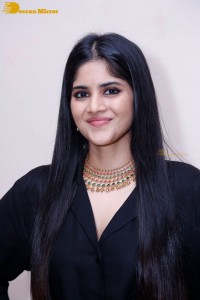 Actress Megha Akash in a black dress