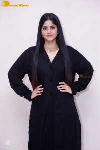 Actress Megha Akash in a black dress