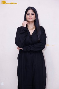 Actress Megha Akash in a black dress