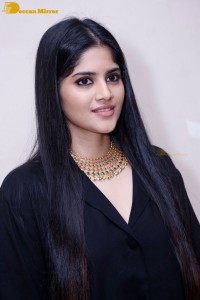 Actress Megha Akash in a black dress