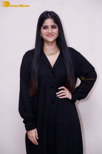 Actress Megha Akash in a black dress
