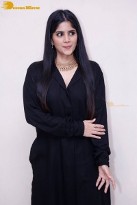 Actress Megha Akash in a black dress