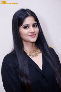 Actress Megha Akash in a black dress