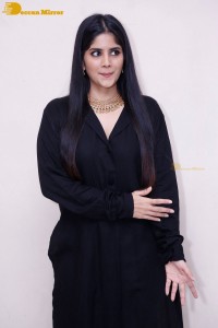 Actress Megha Akash in a black dress