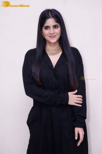 Actress Megha Akash in a black dress