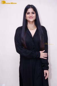Actress Megha Akash in a black dress