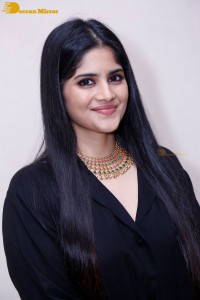 Actress Megha Akash in a black dress