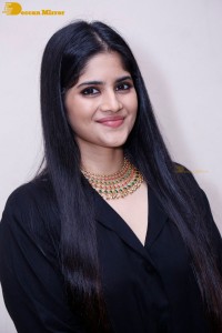 Actress Megha Akash in a black dress
