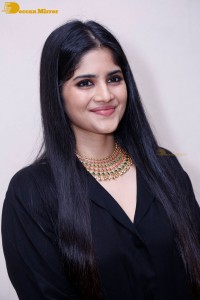 Actress Megha Akash in a black dress