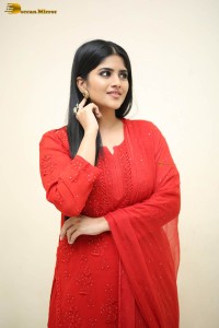 actress megha akash dressed in a red salwar suit