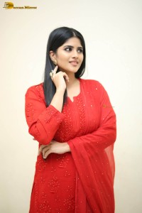 actress megha akash dressed in a red salwar suit