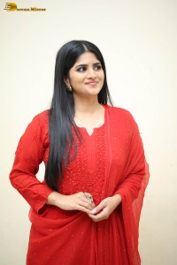actress megha akash dressed in a red salwar suit