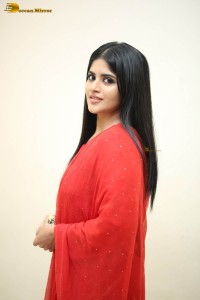 actress megha akash dressed in a red salwar suit