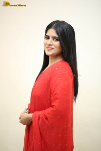 actress megha akash dressed in a red salwar suit