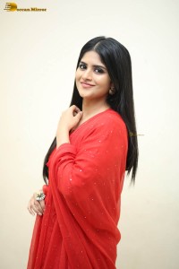 actress megha akash dressed in a red salwar suit