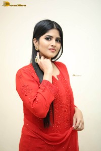 actress megha akash dressed in a red salwar suit
