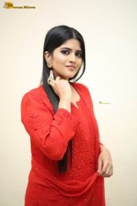 actress megha akash dressed in a red salwar suit