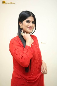 actress megha akash dressed in a red salwar suit