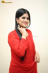 actress megha akash dressed in a red salwar suit