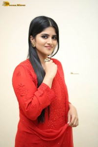 actress megha akash dressed in a red salwar suit
