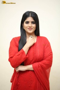 actress megha akash dressed in a red salwar suit