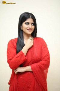 actress megha akash dressed in a red salwar suit