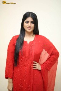 actress megha akash dressed in a red salwar suit