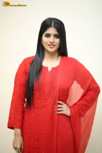 actress megha akash dressed in a red salwar suit