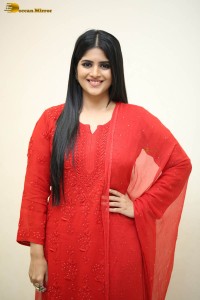 actress megha akash dressed in a red salwar suit