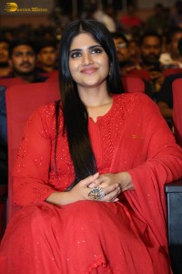 actress megha akash dressed in a red salwar suit