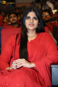 actress megha akash dressed in a red salwar suit