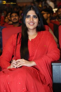 actress megha akash dressed in a red salwar suit