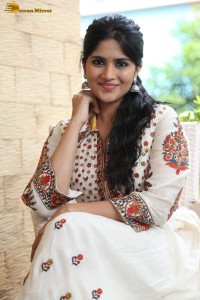 actress megha akash in a white shirt and skirt